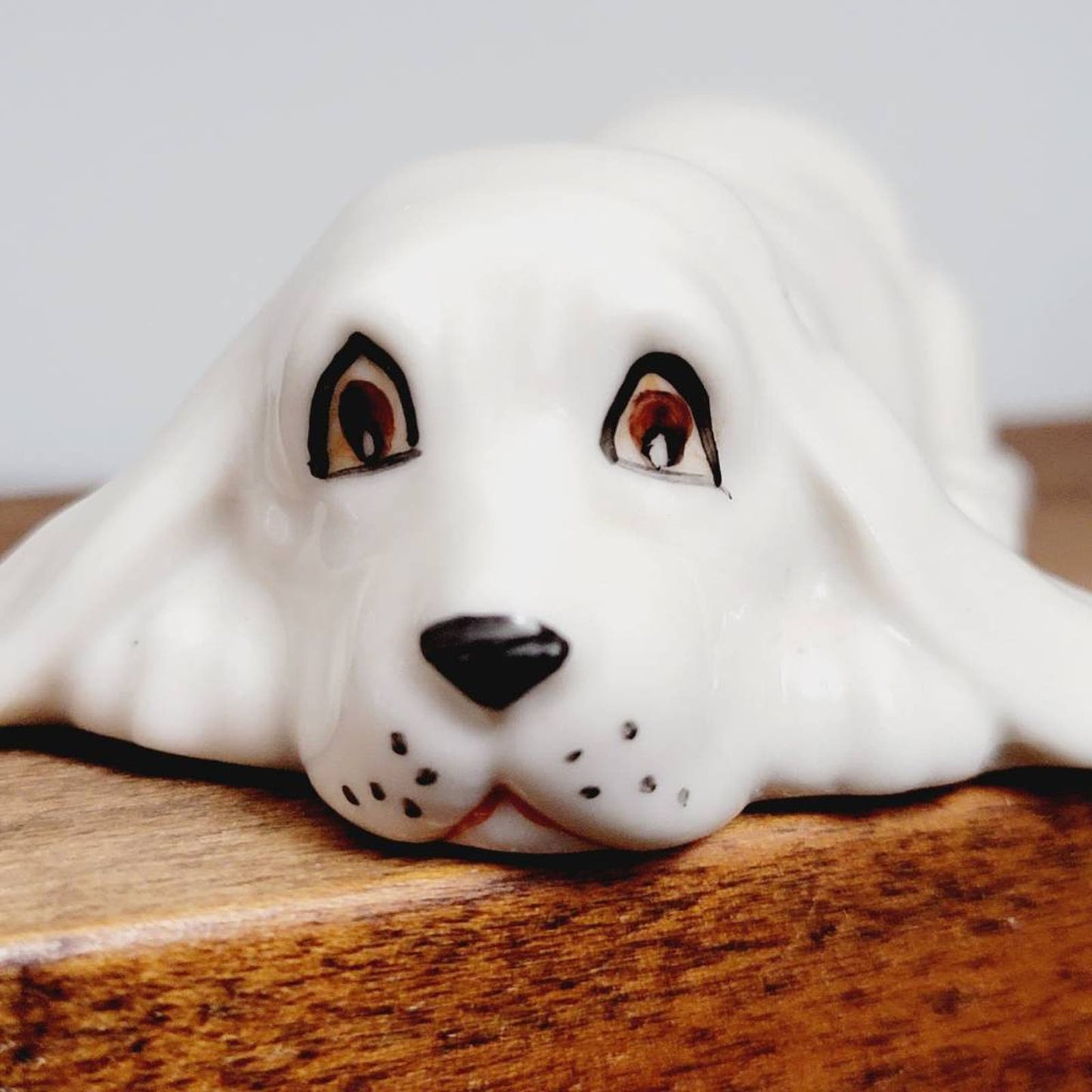 White Ceramic Hound Dog Figurine SDAC Hand Painted Eyes Nicola Lying Down 3.5"