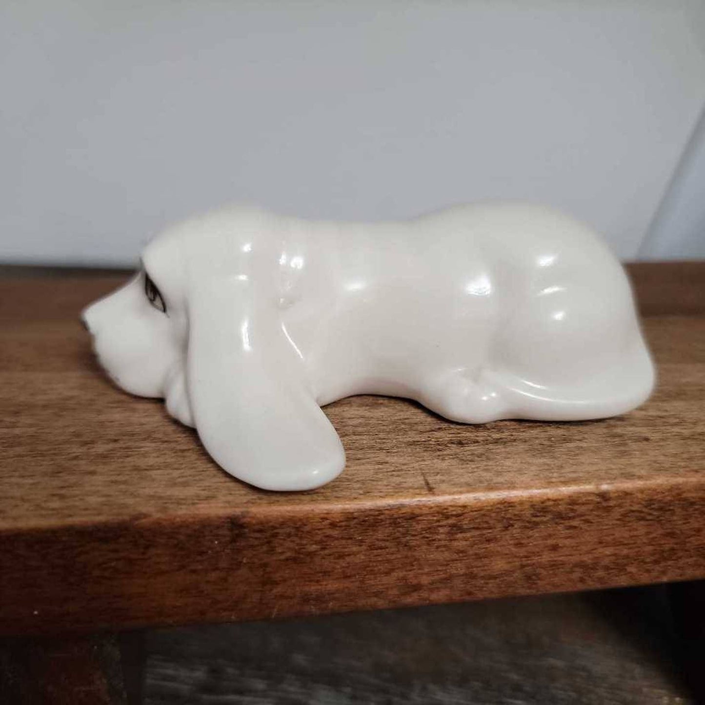 White Ceramic Hound Dog Figurine SDAC Hand Painted Eyes Nicola Lying Down 3.5"